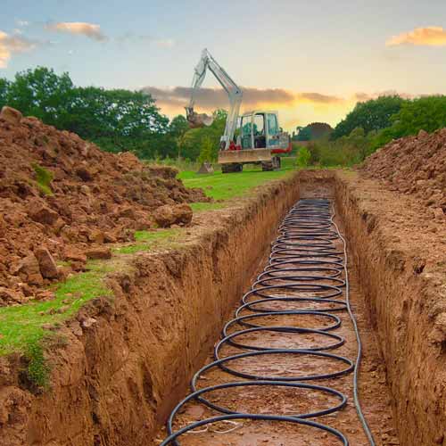 Ground source heat pump collector pipe laid in a long trench
